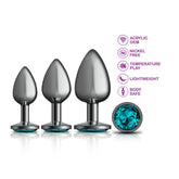 Experience the elegance of the Cheeky Charms Metal Butt Plug Gunmetal Anal Trainer Kit – Teal. This booty jewelry set includes three metallic butt plugs in different sizes, each embellished with a teal gem. Explore its features, such as nickel-free construction, adaptability for temperature play, lightweight design, and body-safe materials.